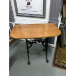 A Heavy cast iron base table fitted with a teak curved top, Could be used as a window table or