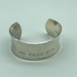 A White metal bangle, Engraved with Tiffany & Co lettering.