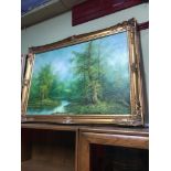 A Large Oil painting on canvas depicting river and wood land scene. Signed Hanrey. Gilt frame