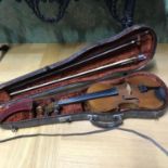 An Antique Violin, two bows and case. Violin is manufactured by The Carrodus Violin Company dated