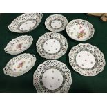 A Collection of Schumann Dresden pierced dishes and bowls detailed with floral designs
