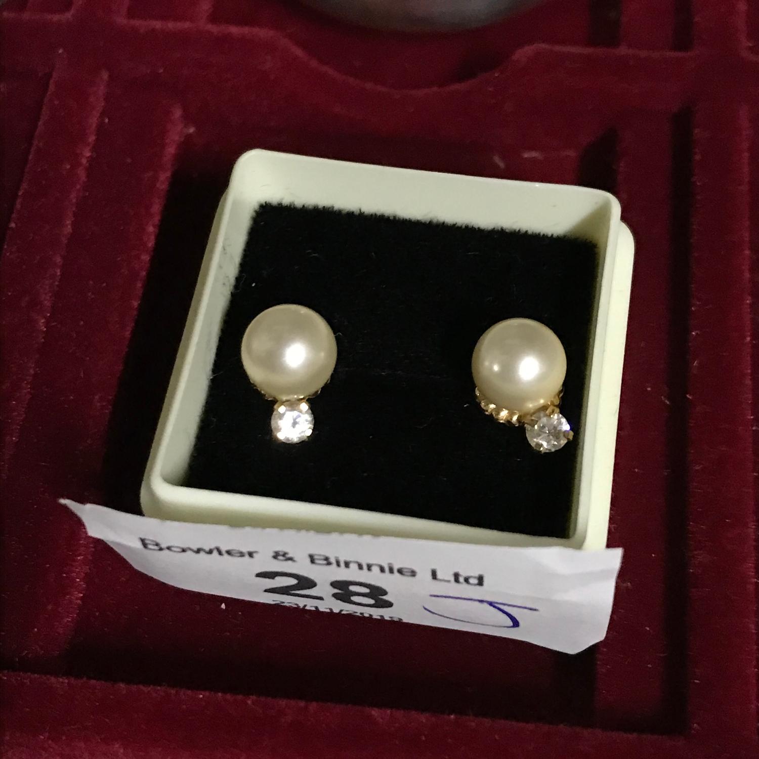 A Pair of 18ct gold ladies earrings set with single pearls and Clear Stones