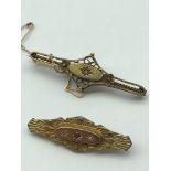 A Victorian 9ct gold ornate bar brooch set with two clear stones and single ruby stone, Together