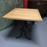 A Heavy cast iron base, solid light oak top table, Ideal for kitchen table. Measures 71x90x75cm