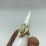 An 18ct Gold ladies ring set with a large Opal stone setting. Weighs 5.22grams. Ring size M.