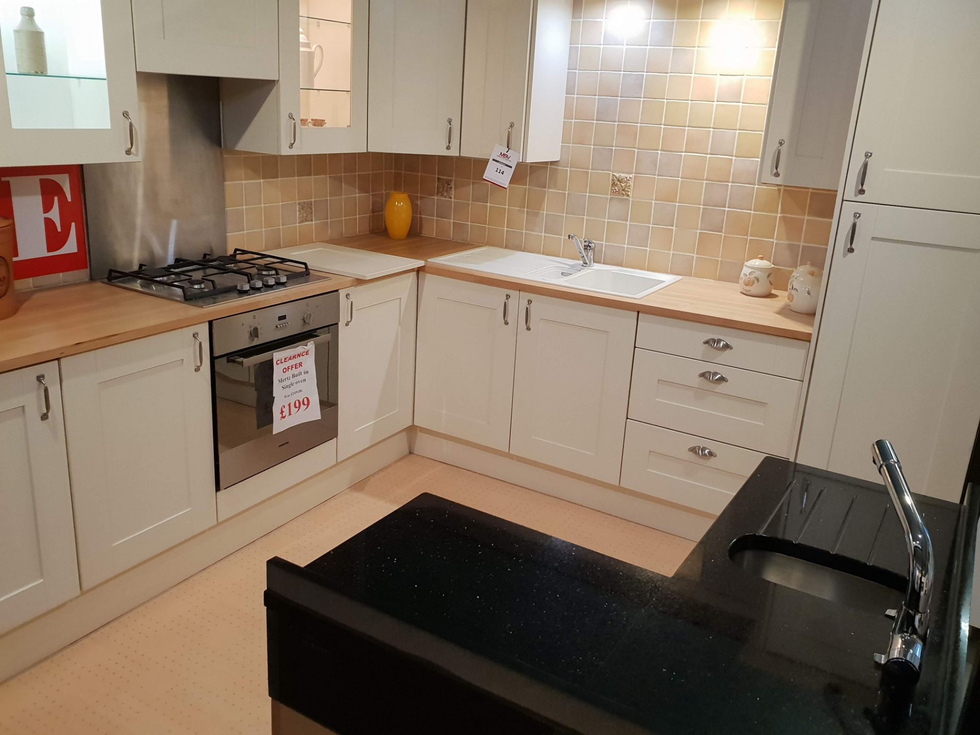 White kitchen display with beech effect and black work surfaces. - Image 2 of 5