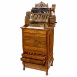 NCR Cash Register Model 567-E-6-FS, c. 1910Floor model, bronze cash register, tiger-oak case, 6