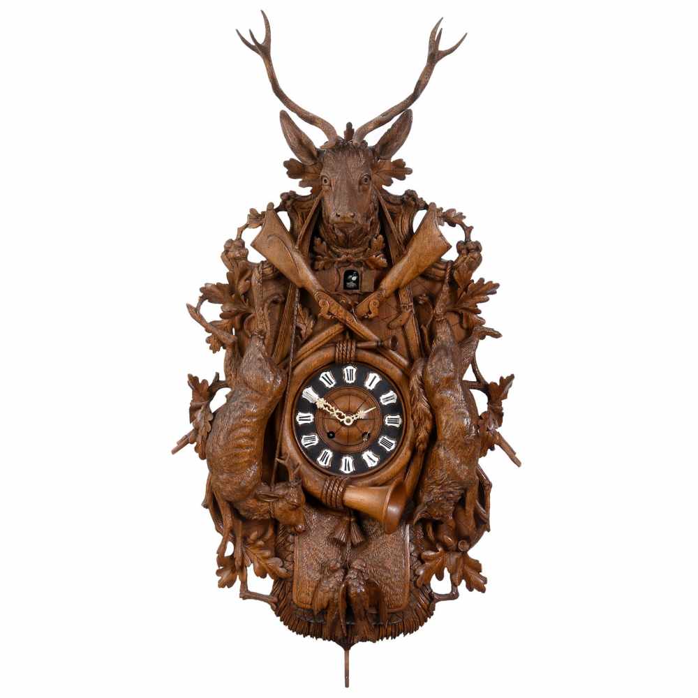 Large Black Forrest Cuckoo Clock, c. 1915In elaborate carved walnut case decorated with game (