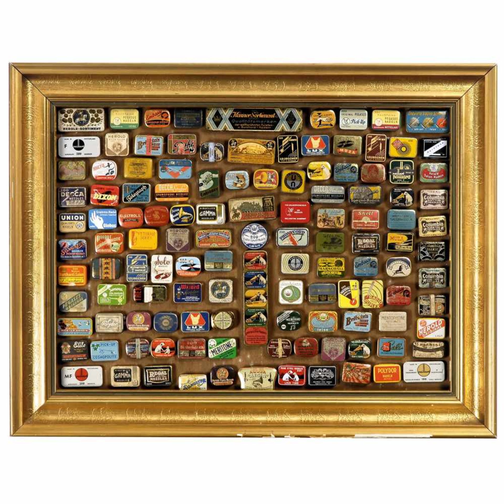 Showcase with 124 Needle TinsGilded frame, size 31 ½ x 24 4/5 in., with assortment tins and