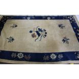 A Chinese rug, the ivory ground with a blue border, 239 x 148cm