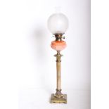 An antique banquet lamp with a brass and marble Corinthian column base, a brass duplex burner and