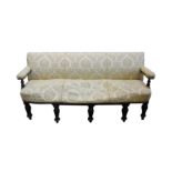 A mid 19th century mahogany upholstered sofa with rectangular back open arms on turned supports