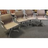 A set of four Eames for Vitra chrome chairs and swivel seats