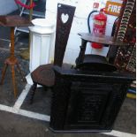 An early 20th Century oak sewing chair, with floral carved decoration and heart cut out motif to the