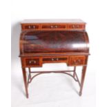 An Edwardian mahogany and crossbanded cylinder bureau enclosing pull out tooled leather inset