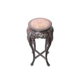 An Oriental marble topped hardwood jardiniere stand 93cm high