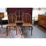 A set of eight ash and elm Windsor chairs, each with wheel back by Thomas Glenister, to include