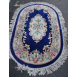 A Chinese blue ground rug and another