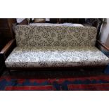 Two teak day beds - one with cream cushions and one with black floral print on cream cushions.