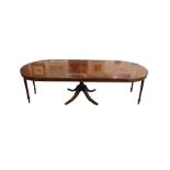 A Bevan Funnell Reprodux mahogany and crossbanded extending dining table, with three additional