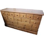 A pine chest of nineteen drawers 94cm high, 180cm length