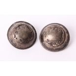 A pair of large unmarked white metal coat buttons, stamped 'EG 85'.