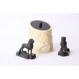 A pair of bronze lion desk weights, together with an ivory pot, base and lid of ebony, carved with a