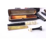 A boxed amber and meerschaum cheroot holder, and an inlaid ivory cheroot holder; together with