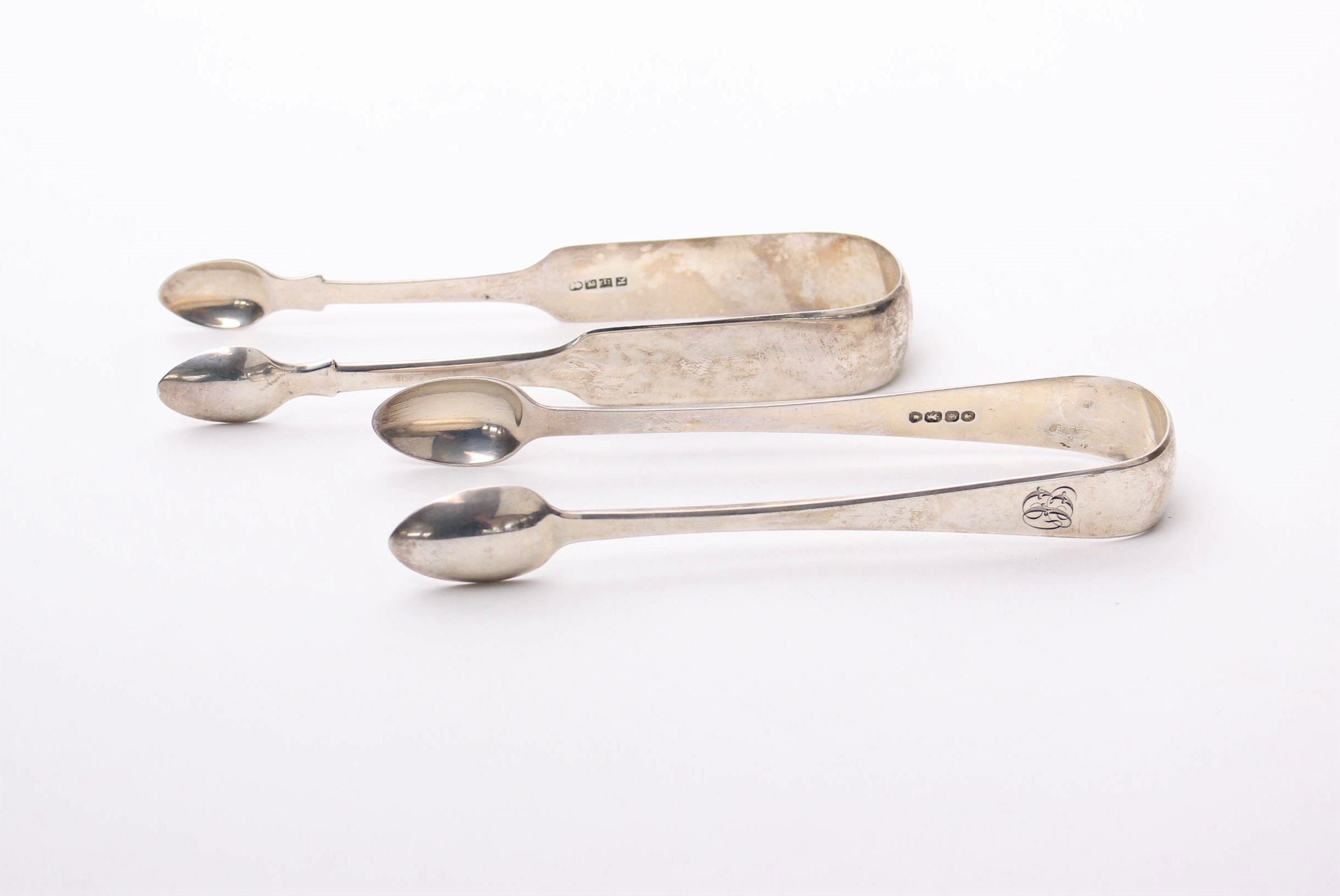 Two pairs of sterling silver sugar tongs, Exeter 1826 and London 1841, 3ozt.