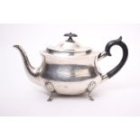 A sterling silver tea pot raised on rococo style feet with ebony handle and finial 24.5ozt, by