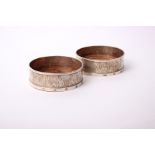 A pair of 21st Century sterling silver wine coasters, with bark effect decoration and turned