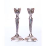 A pair of sterling silver candlesticks by P H Vogel & Co, Birmingham 1974, 6.40ozt gross.