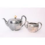 A Wilcox & Co USA silver plated tea pot and matching sugar bowl, with chased vine and leaf