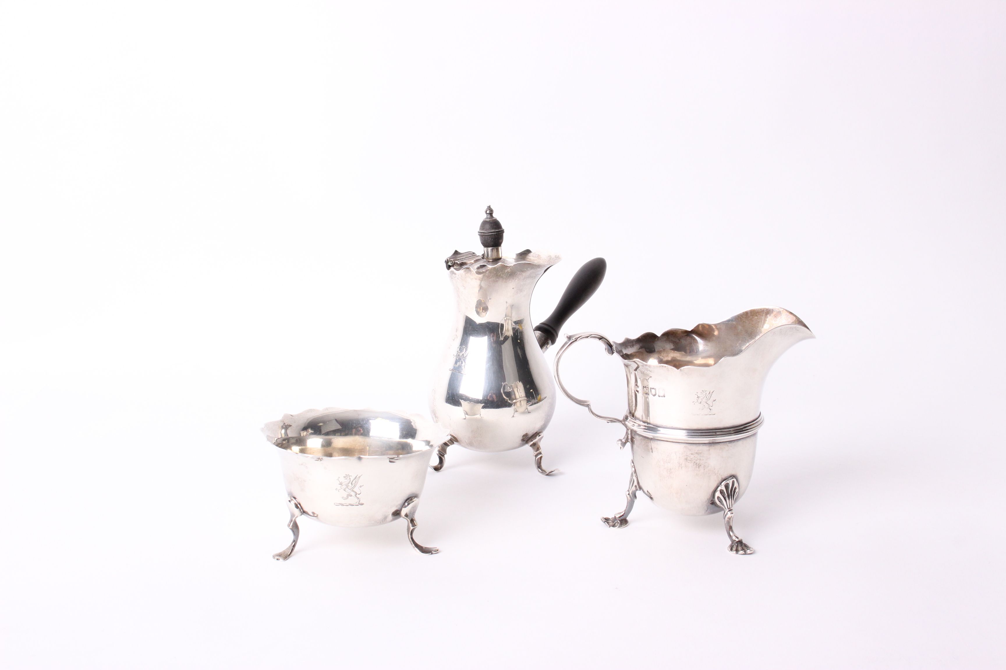 A silver chocolate pot by Mappin & Webb, Sheffield 1902; together with a milk jug, London 1906;