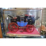 A cased model of an English coach carriage of circa 1830, 33.5cm wide, (modern)