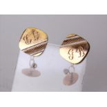 Two pairs of 9ct gold cuff links, a pair of rose gold bullet shaped cuffs, and a pair of square cuff