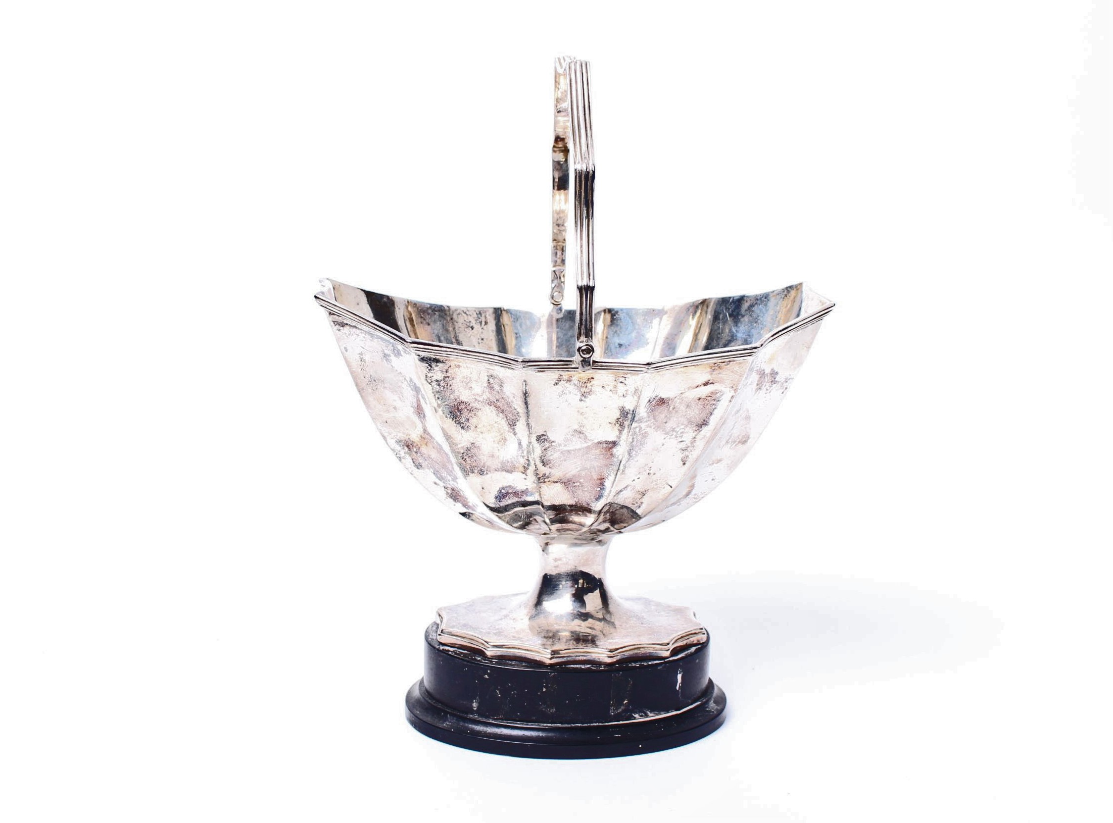 A Georgian sterling silver scalloped shaped footed bowl, with swing handle on ebony base, by William