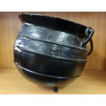 A black painted five-gallon cauldron
