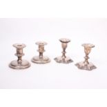 Two pairs of silver plated candlesticks.