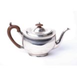 A sterling silver tea pot with fruitwood handle and finial by Horace Woodward & Co, Birmingham 1919,