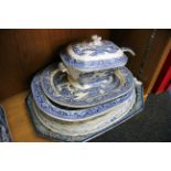 A willow pattern lidded tureen, together with seven blue and white meat plates.