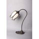 A bronze table lamp in the Art Nouveau style, decorative cast base with opalescent glass tulip