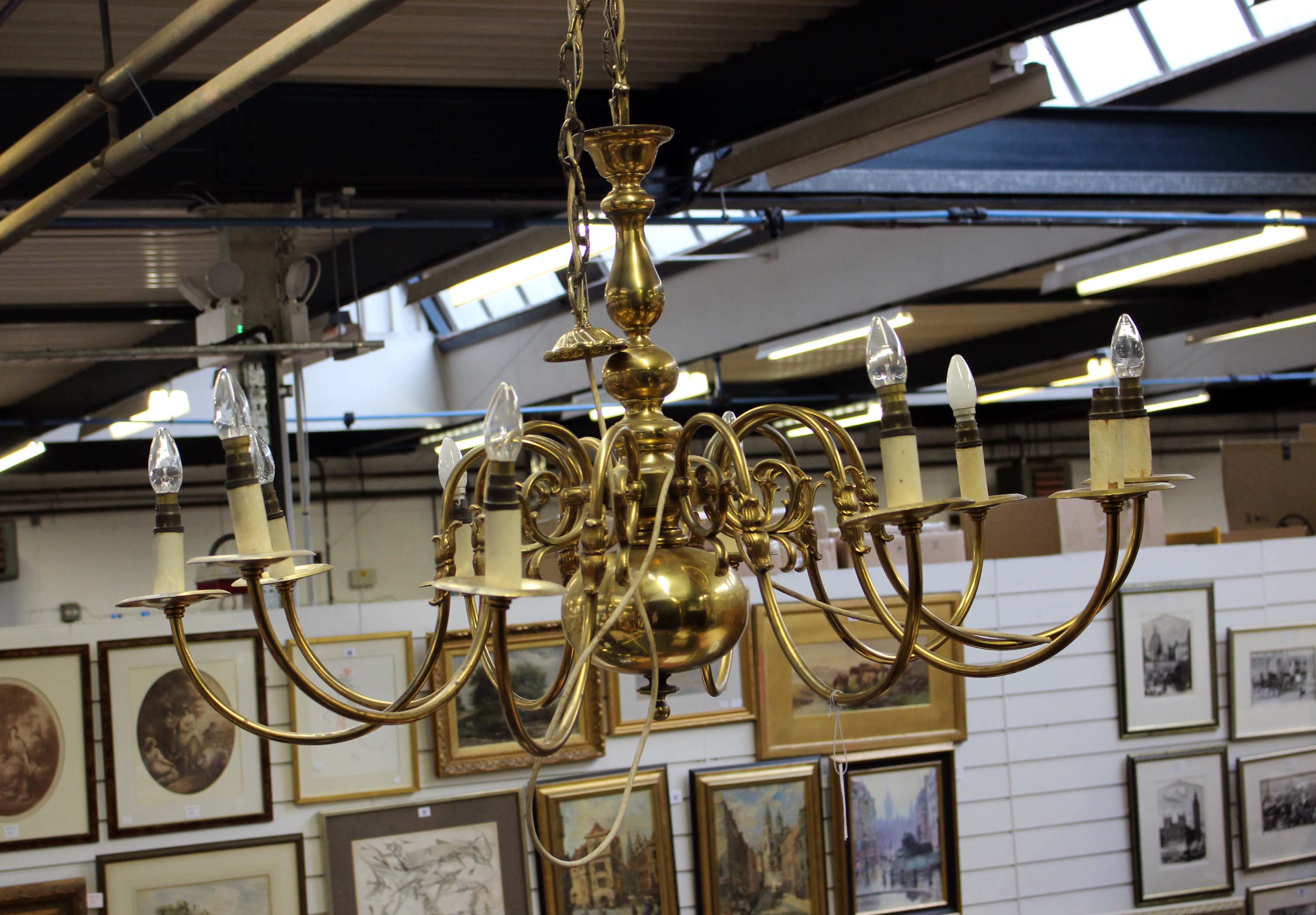 An Edwardian brass ten branch chandelier, with S-scroll brackets. Fitted for electricity. 112cm