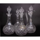 A suite of three decanters and stoppers together with a matching claret jug (4)