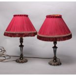 A pair of silver plated candlesticks converted to lamps together with seven ornate lamp shades.