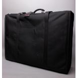 A Tumi black suitcase