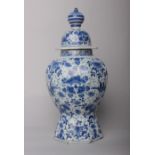 An early 18th Century delft vase and cover of octagonal baluster form painted in blue in the Chinese