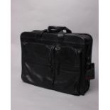 A Tumi black leather expandable laptop briefcase, with owner's initials and company name.