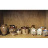 A collection of Doulton slipware pottery to include a tyg, tobacco jar, teapot, a Mortlock