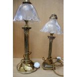 Two brass Corinthian column table lamps on square stepped bases with ornate ribbed glass shades,